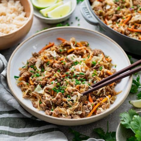 Square side shot of a bowl of egg roll in a bowl with coleslaw mix and ground pork.