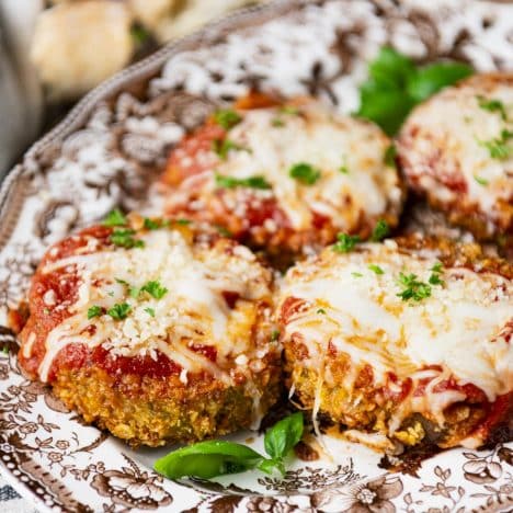 Close up square side shot of a platter of Grandma's baked eggplant parmesan recipe.