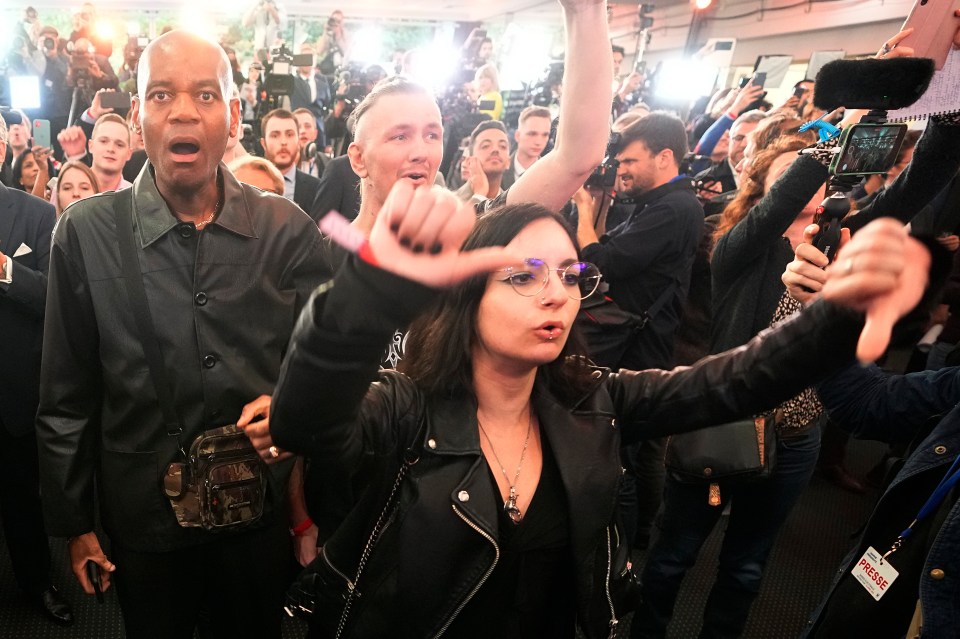 Supporters of far-right leader Marine Le Pen react as they hear the early result projections