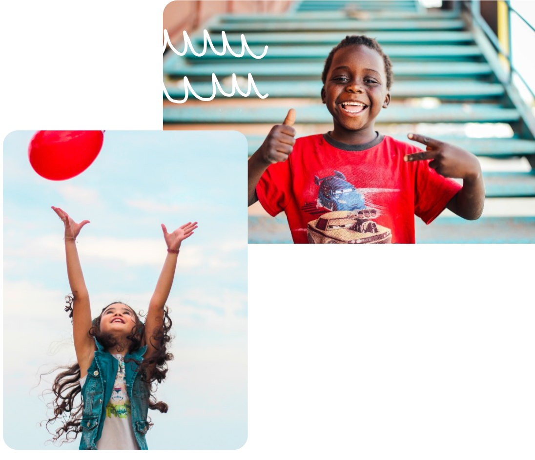 Two children one holding a colorful balloon smiling and having fun.