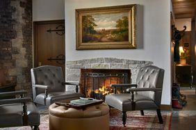 Chairs in front of a fireplace at Deer Path Inn