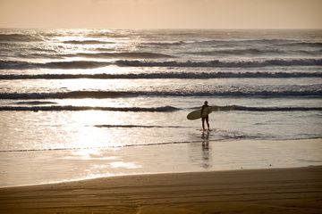 A surfer on the beach at South Padre Island, Texas