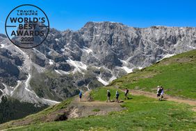 A group of people hiking through the mountains