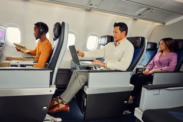 A passenger on board a Delta airplane using his laptop mid-flight