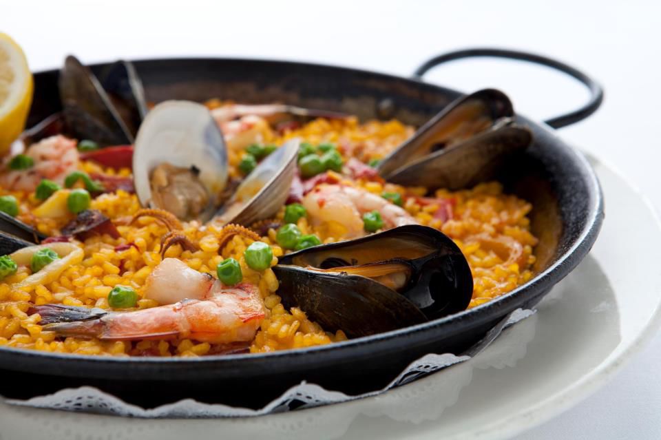 seafood paella with shrimp mussels and peas in a pan