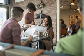 Waitress taking order from couple at a restaurant in Canada