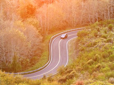 Rural Oregon Coast Curvy Road with Car in Curve Sunset