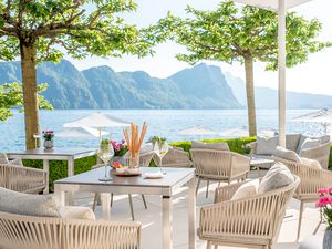 Terrace dining with view of a lake and mountains in Switzerland