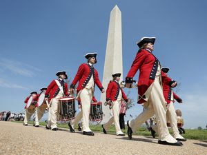 The US Army Old Guard Fife and Drump Corps marches near the Washington Monument in Washington, DC.