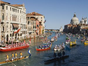 Grand Canal Venice Italy. Regatta Regata Storica procession of boats down the Grand Canal annually first Sunday in September. Church Santa Maria della Salute