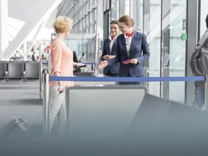 Tourists boarding at airport departure gate