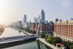 Modern bridge going over a river in a Chinese city with soft light