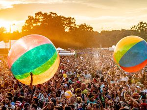 Crowd playing with giant beach balls at Bonnaroo