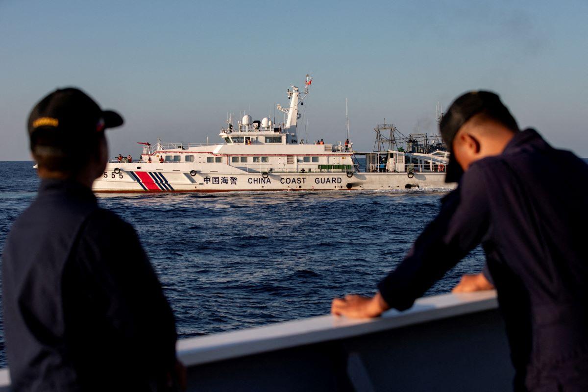 Members of the Philippine Coast Guard stand alert as a Chinese Coast Guard vessel blocks their way to a resupply mission at Second Thomas Shoal in the South China Sea, March 5, 2024. REUTERS/Adrian Portugal