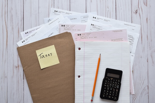 file folder with calculator and pencil tax prep checklist