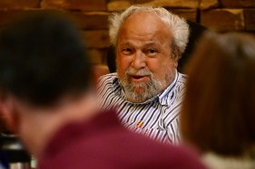 Former St. Paul Mayor George Latimer smiles as he talks to people.