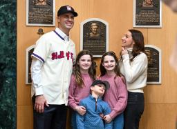 a baseball Hall of Fame inductee poses for photos