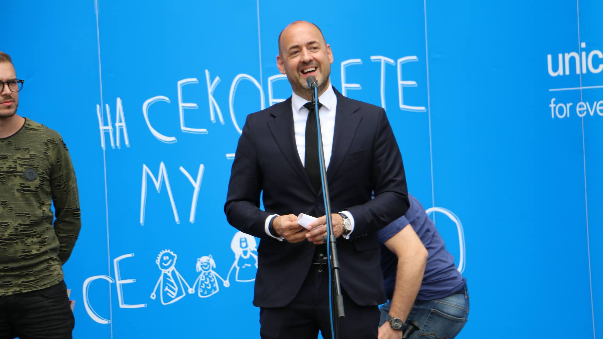 Benjamin Perks in front of screen with drawings