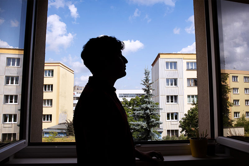 Une personne en contre-jour à la fenêtre