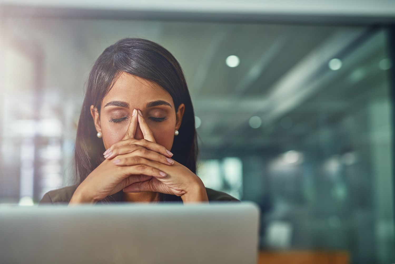 young businesswoman looking stressed out while working in an office