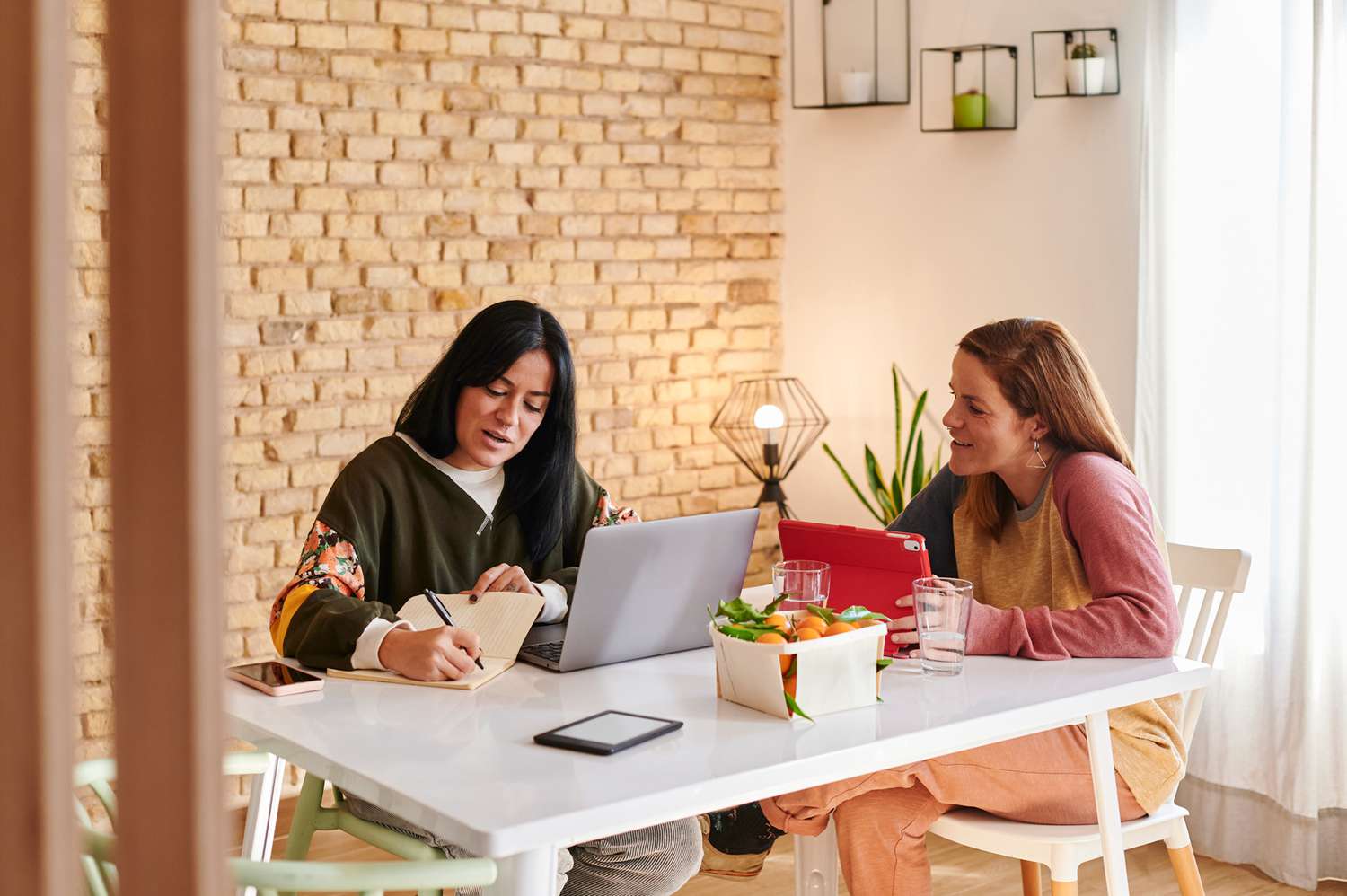 lesbian couple working on their computers at home