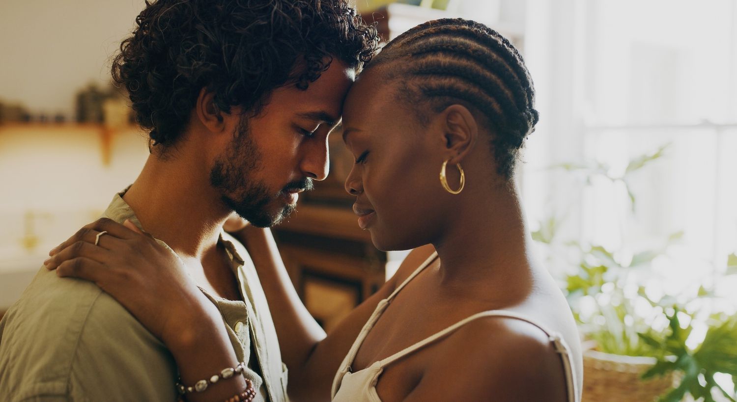 BIPOC couple showing affection with their foreheads touching