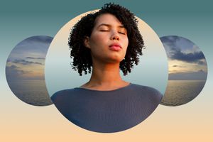 Woman with curly hair meditating against ocean backdrop