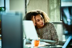 woman looking bored at desk