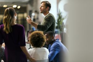 businessman talking to colleagues at work