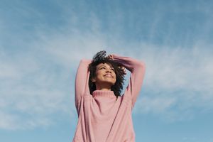 Happy woman with arms raised