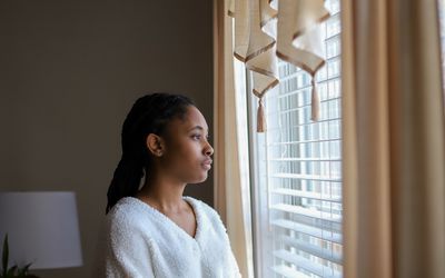 Woman looking out of window