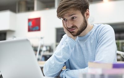 Student using laptop in a university library