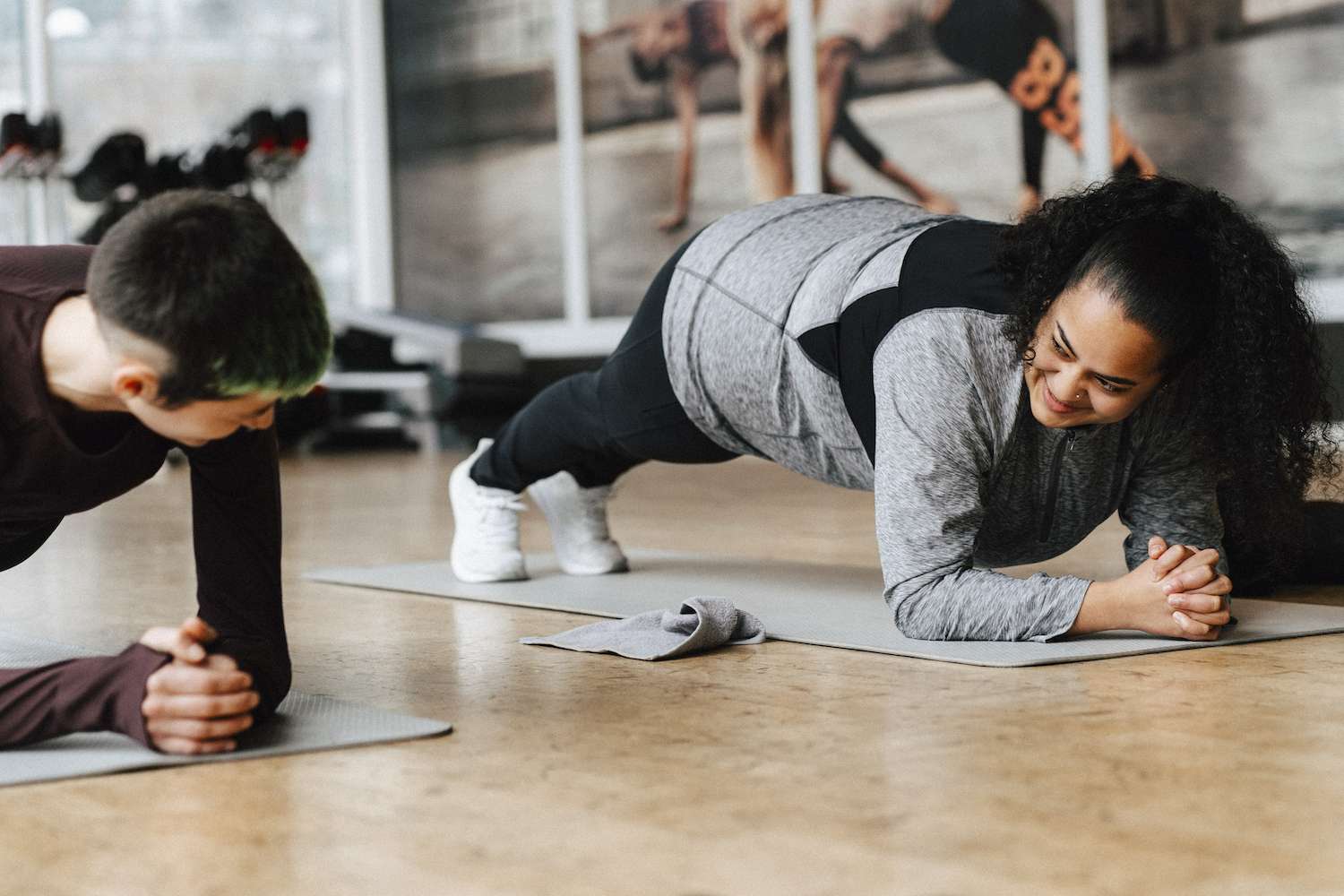 People practicing plank position in gym