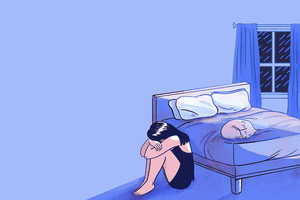 person sitting on the floor near bed depressed