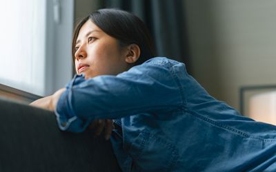 person depressed near window