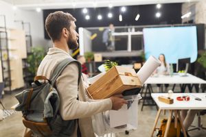 man quitting his job carrying the items from his desk