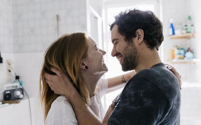 Couple Affectionately Embracing And Smiling Together