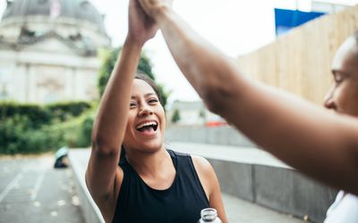 Two women giving high five after workout