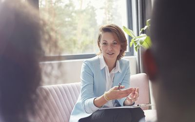 Female therapist talking to couple in couples therapy session