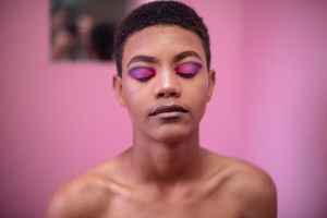 Close up portrait of young queer person against pink background,Port Elizabeth,South Africa