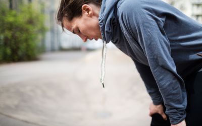 Woman bending over breathing deeply