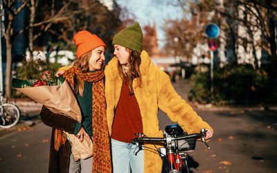 Lesbian couple taking romantic stroll in the fall