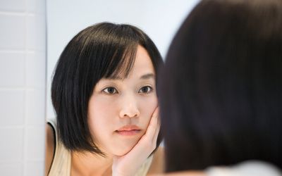 Woman looking in the mirror