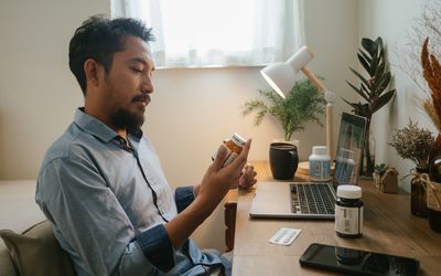 A person with a medication bottle