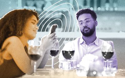 Woman phubbing her partner at dinner