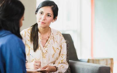 Caring counselor listening to female patient