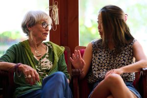 Mother-in-law speaking with her daughter-in-law at home