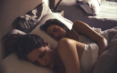 Happy women lgbtqi couple resting in the bed in the morning.