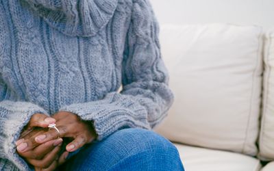 Close-up of unrecognizable black woman removing ring from finger