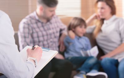 Family with child visiting a psychologist.